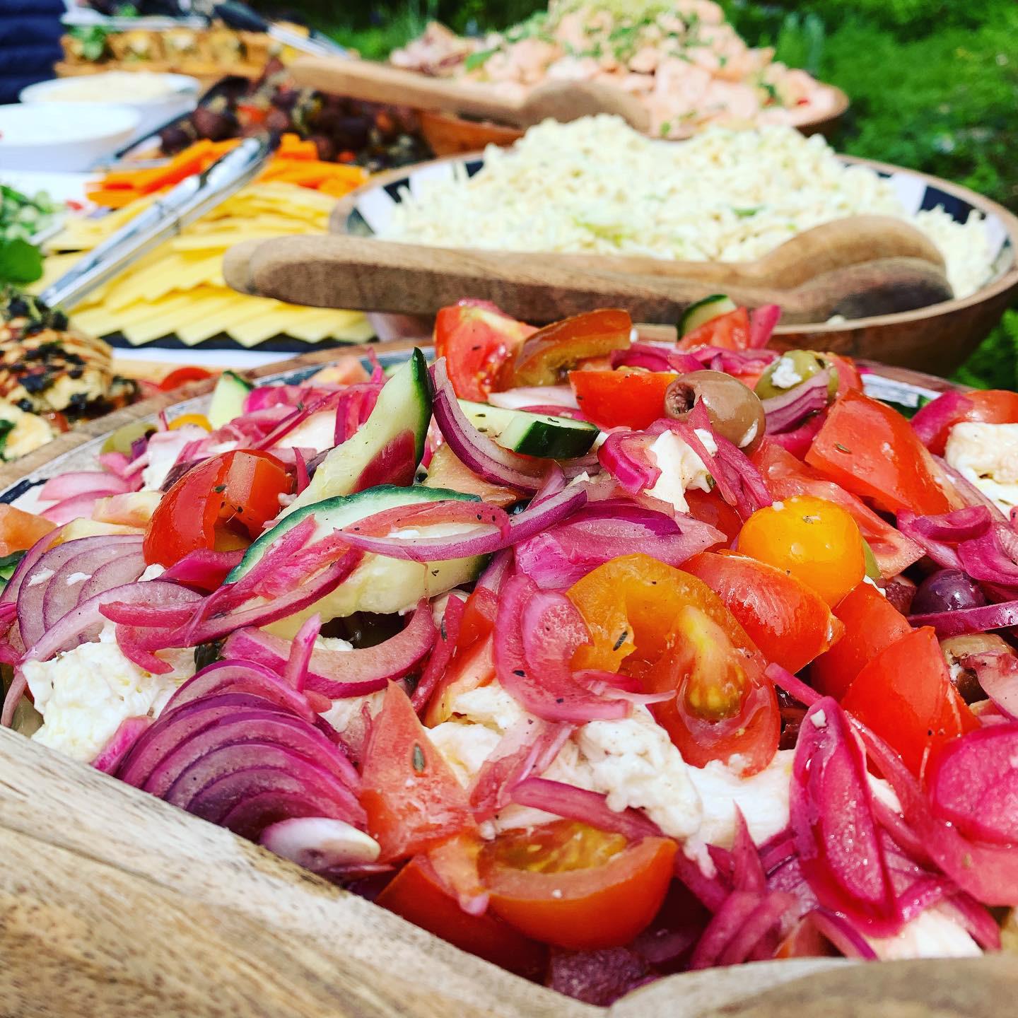 Colourful Mediterranean salad spread at an outdoor summer event
